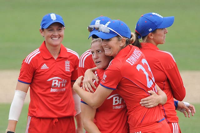 Katherine Brunt  is hugged by Charlotte Edwards after taking the wicket of Jess Cameron