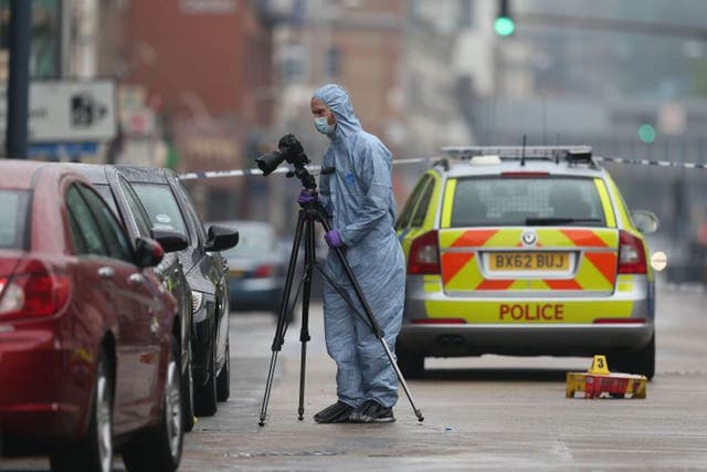 Police at the scene of a shooting in Kilburn High Road,