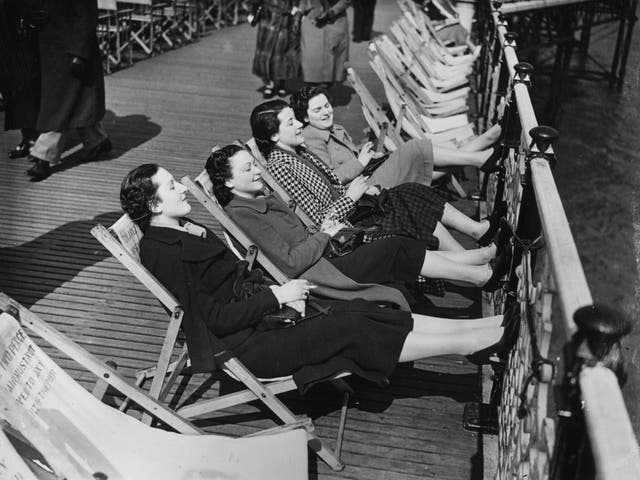 Feet up: Taking the air on a Brighton pier in 1937