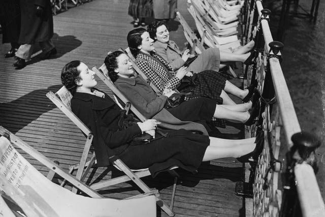 Feet up: Taking the air on a Brighton pier in 1937