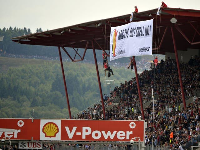Two paragliders from Greenpeace initially flew over the Spa-Francorchamps circuit, trailing a banner slamming the Arctic drilling plans of race sponsors Shell before a second group of four men scaled the main grandstand overlooking the grid then unfurled a banner from the roof that read: "ARCTIC OIL? SHELL NO"