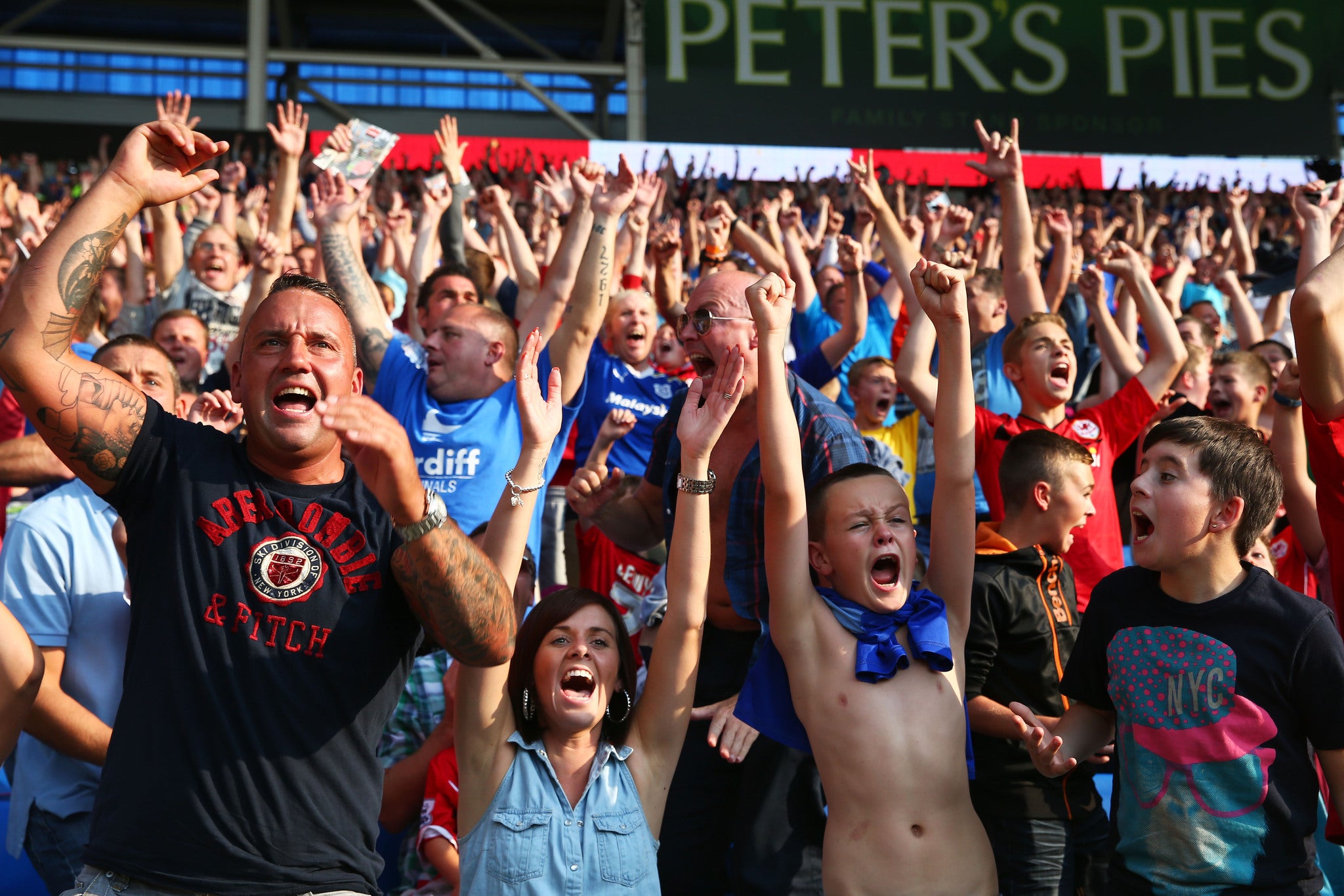 CARDIFF, WALES - AUGUST 25: Cardiff fans celebrate their team's 3-2 victory during the Barclays Premier League match between Cardiff City and Manchester City at Cardiff City Stadium. GETTY IMAGES.
