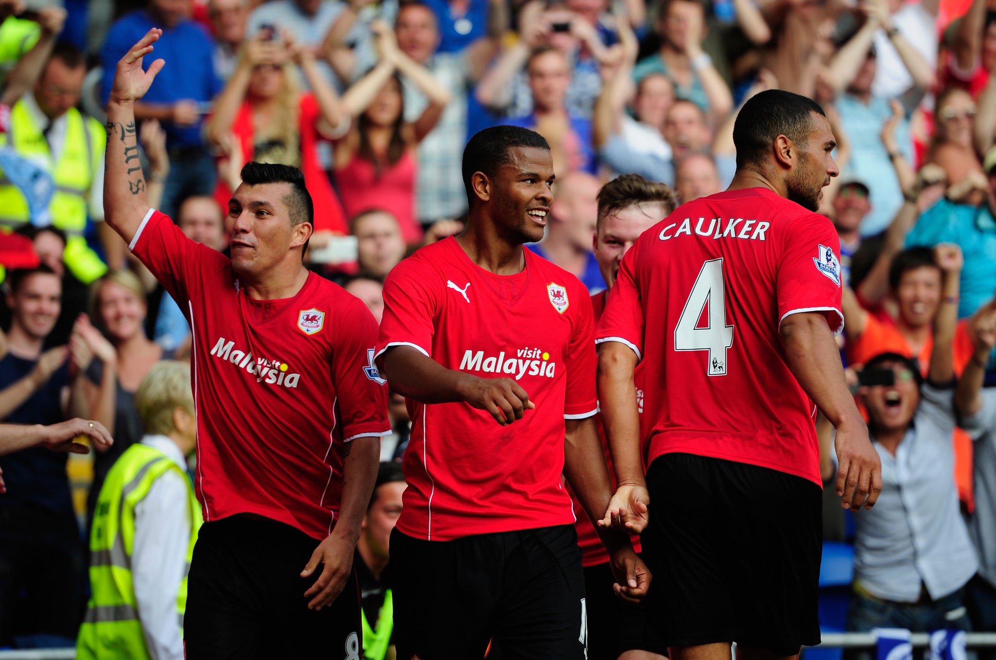CARDIFF, WALES - AUGUST 25: Cardiff City scorers Fraizer Campbell (c) and team mates lead the celebrations after the third Cardiff goal during the Barclays Premier League match between Cardiff City and Manchester City at Cardiff City Stadium.