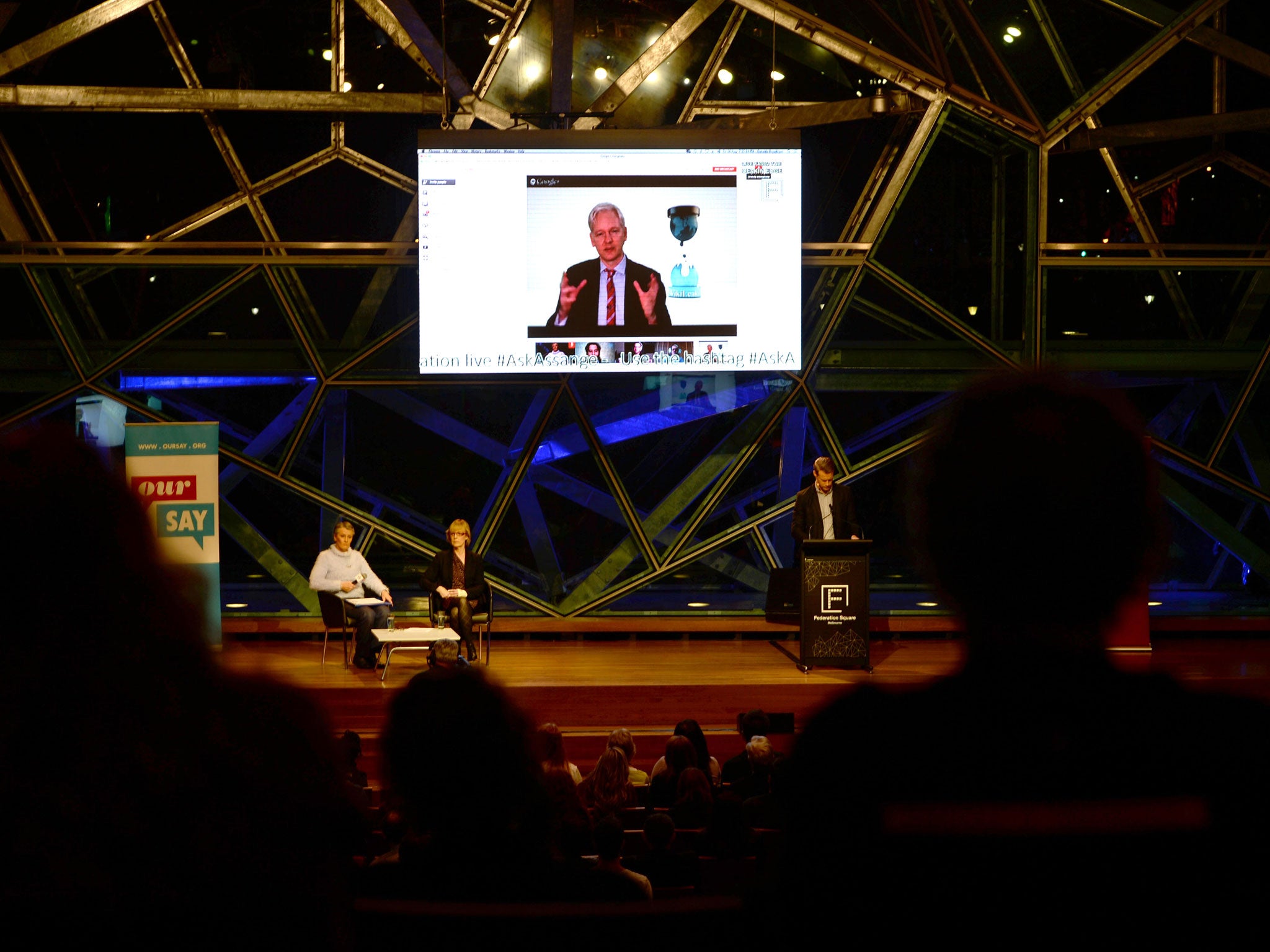 Julian Assange participates in a live question-and-answer session via Skype at a meeting in Melbourne