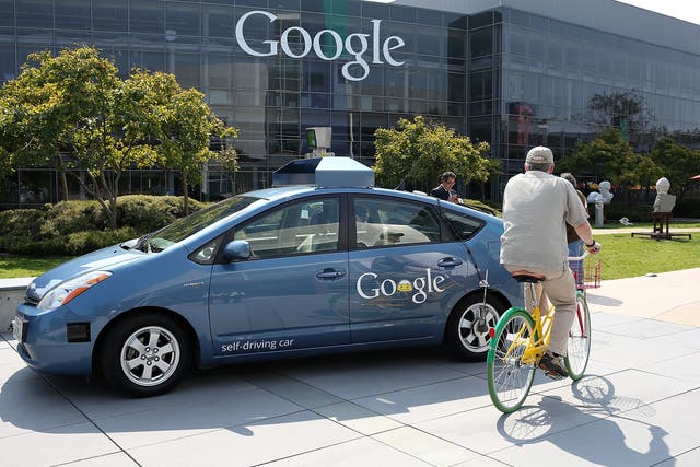  A bicyclist rides by a Google self-driving car at the Google headquarters on September 25, 2012 in Mountain View, California. California Gov. Jerry Brown signed State Senate Bill 1298 that allows driverless cars to operate on public roads for testing pur