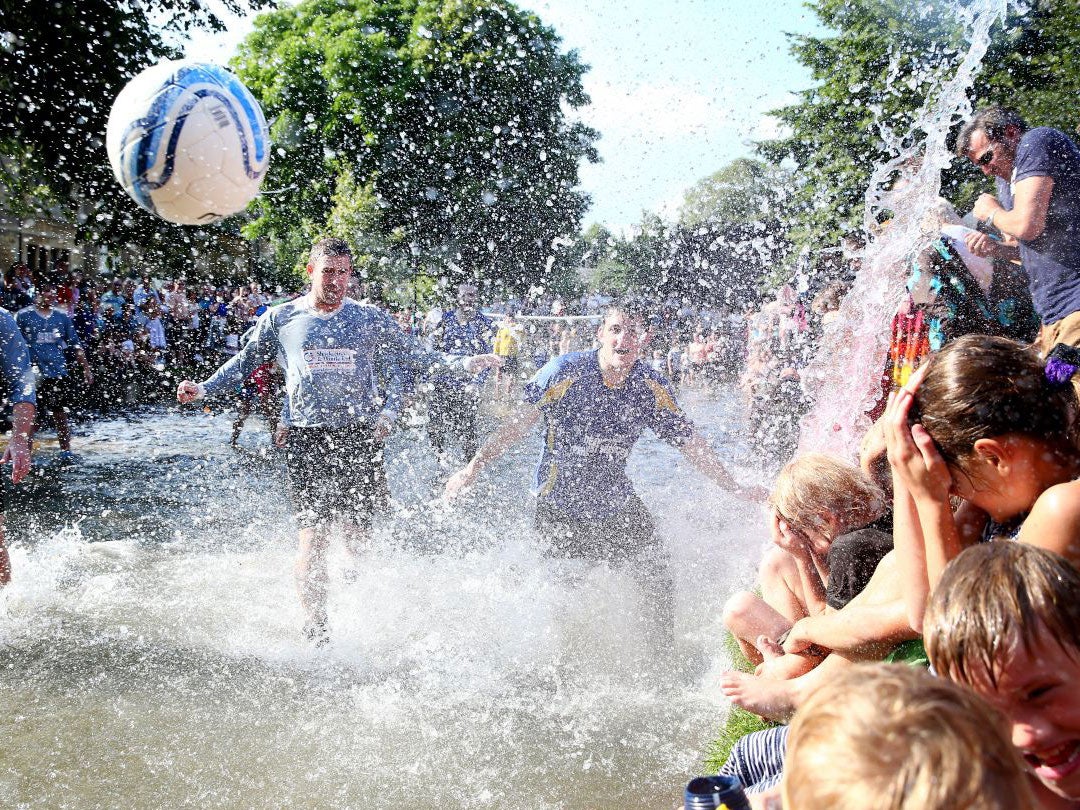 26 August 2013: Bourton Rovers First XI play against Bourton Rovers Second XI during the annual Bourton-on-the-Water Football Match played on the River Windrush, in Bourton-on-the-Water, England.
