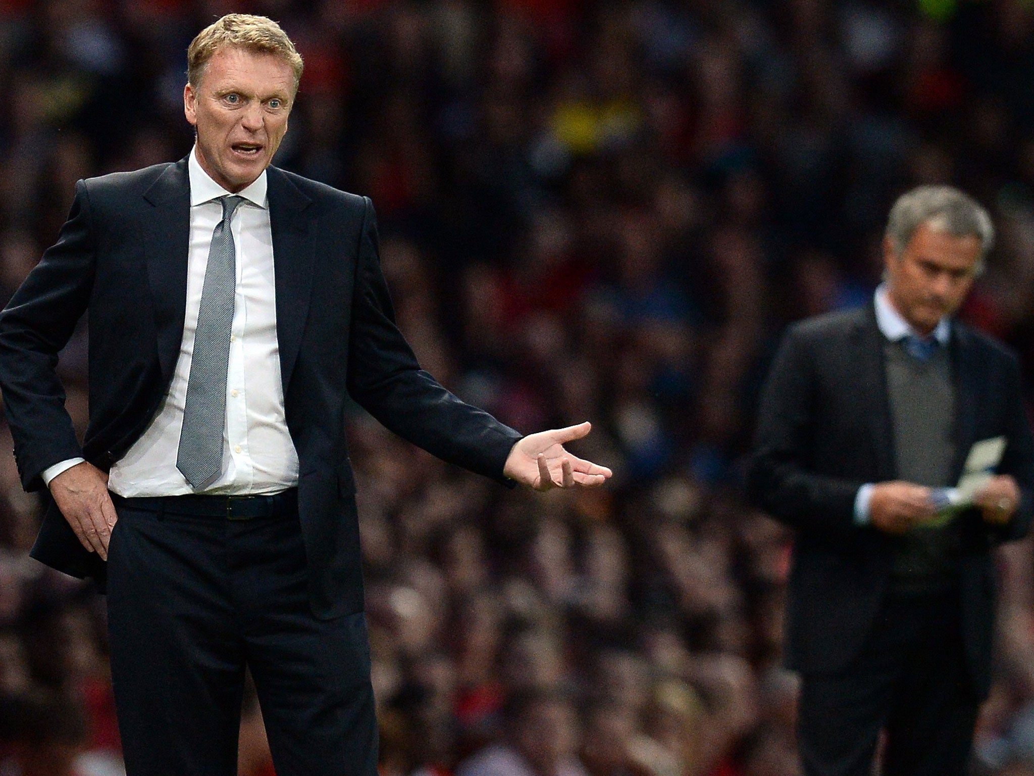 David Moyes (left) prowls the technical area last night as Jose Mourinho takes notes