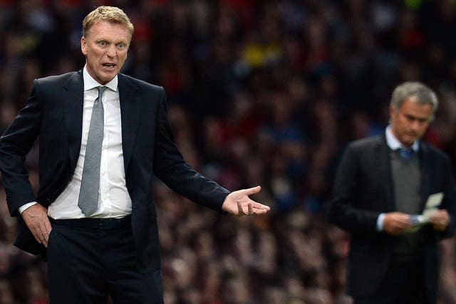 David Moyes (left) prowls the technical area last night as Jose Mourinho takes notes