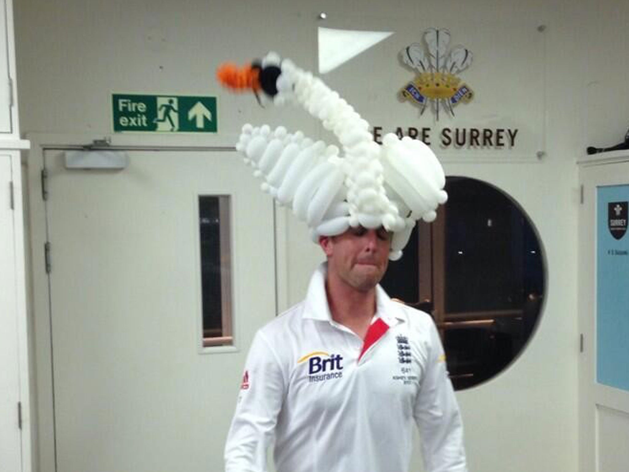 Swann dons a swan balloon hat