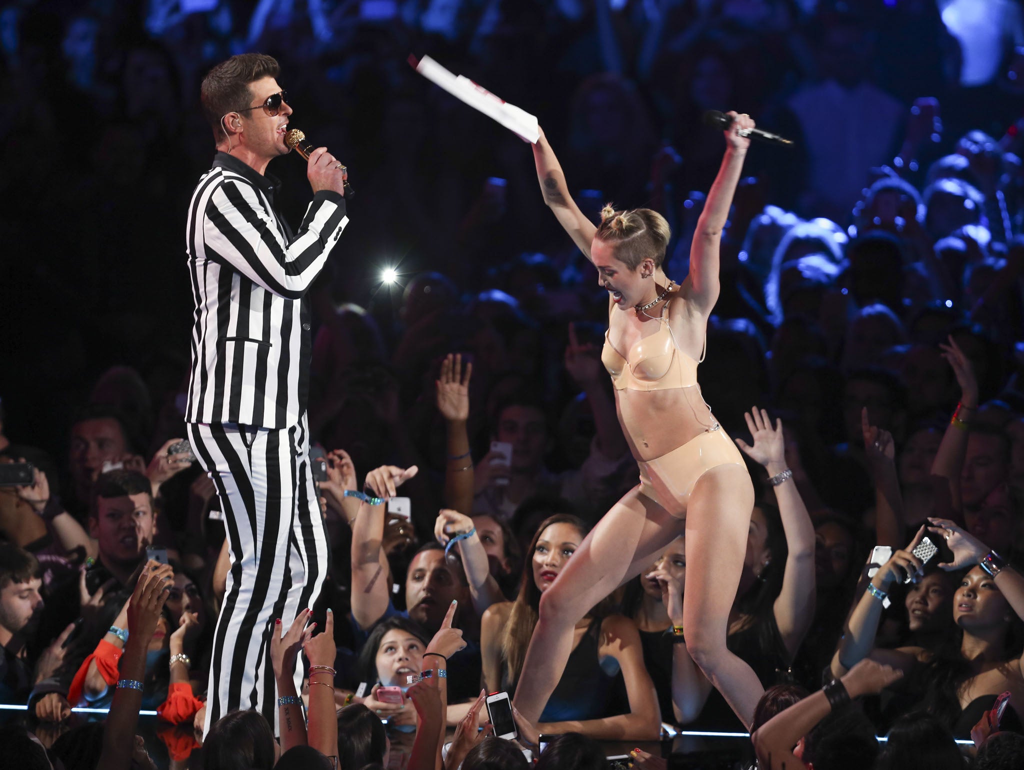 Shaking off her squeaky clean Hannah Montana image: Robin Thicke performs with Miley Cyrus at the VMAs.