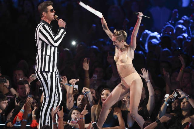 Shaking off her squeaky clean Hannah Montana image: Robin Thicke performs with Miley Cyrus at the VMAs.