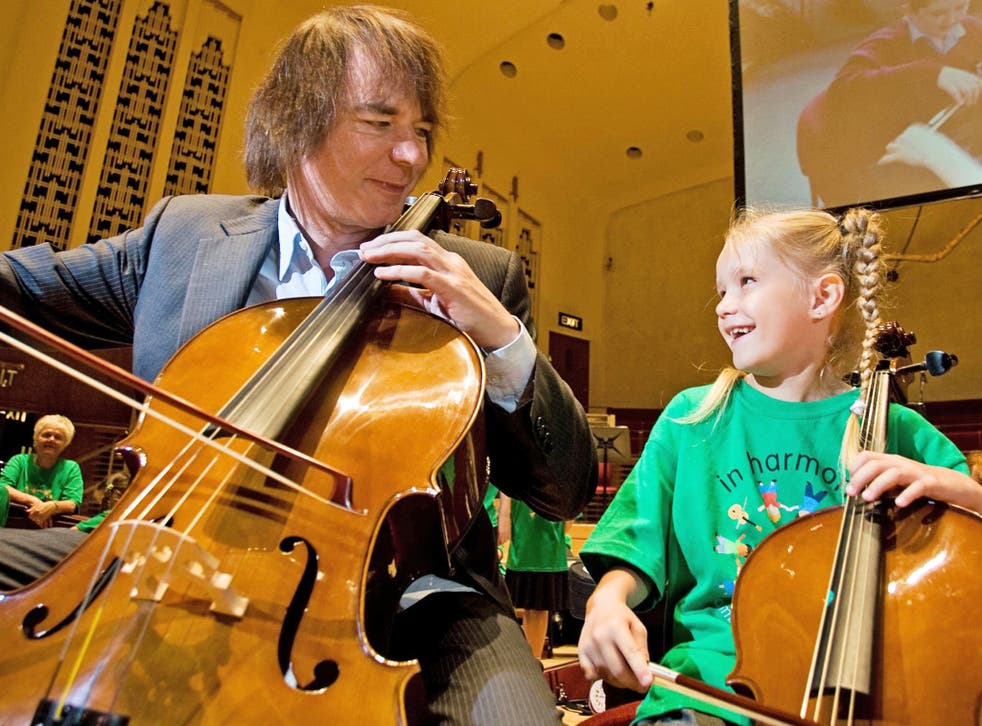 Take a bow: Julian Lloyd Webber plays with six-year-old Lauren Russell, a member of In Harmony