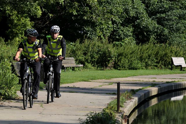 Police officers cycle along the tow path alongside the River Cam in Cambridge where the body of the 12-year-old boy was pulled from the river