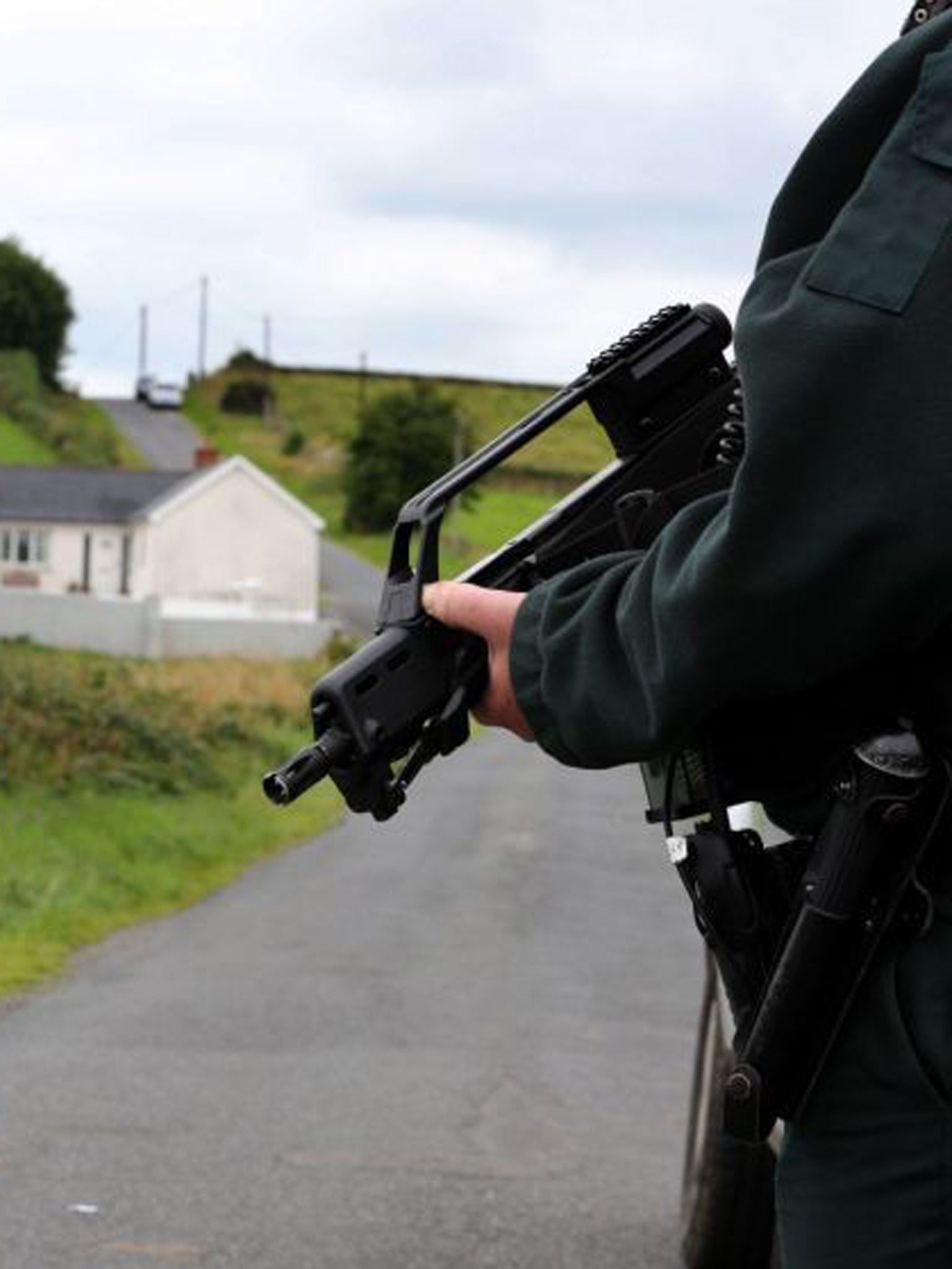 Police at the scene near the village of Cullyhanna, Northern Ireland, where a dissident republican-style rocket launcher has been discovered