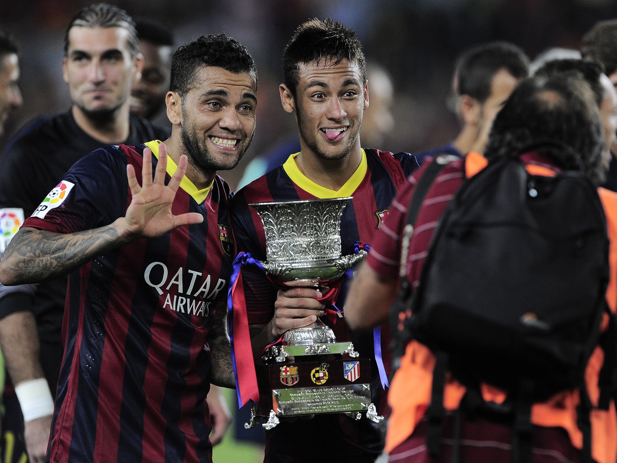 Barcelona's Brazilian defender Dani Alves (L) and Brazilian forward Neymar celebrate with the Spanish Super Cup