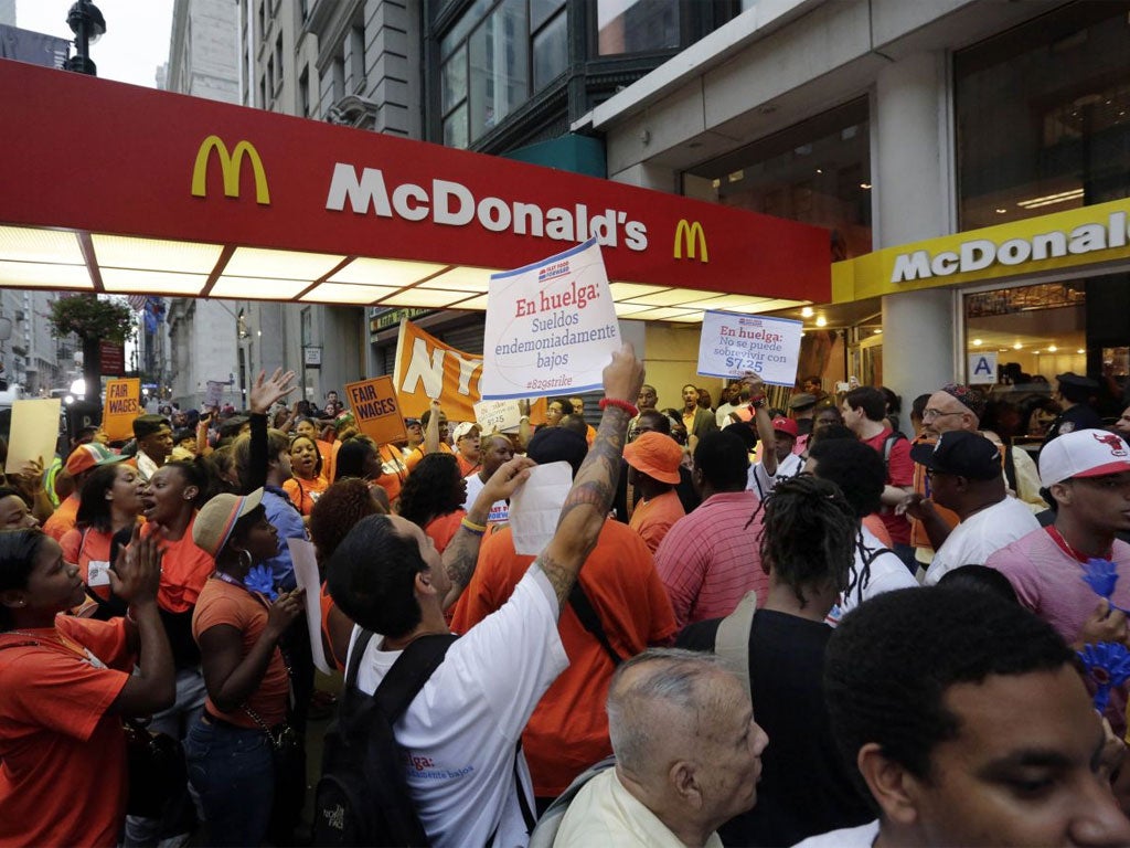 Protesting fast-food workers demonstrate outside a McDonald’s restaurant on New York’s Fifth Avenue