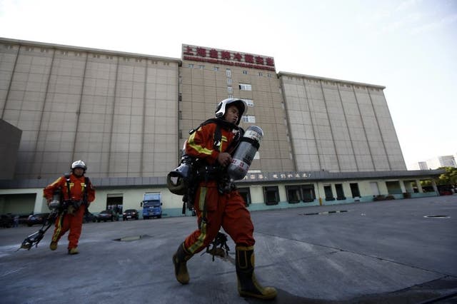 Rescuers walk inside a refrigeration unit of Shanghai Weng's Cold Storage Industrial Co. Ltd., in the Baoshan district of Shanghai August 31, 2013. A liquid ammonia leak from the refrigeration unit at the cold storage facility in Shanghai on Saturday has killed 15 people and injured 26 others, local authorities said.