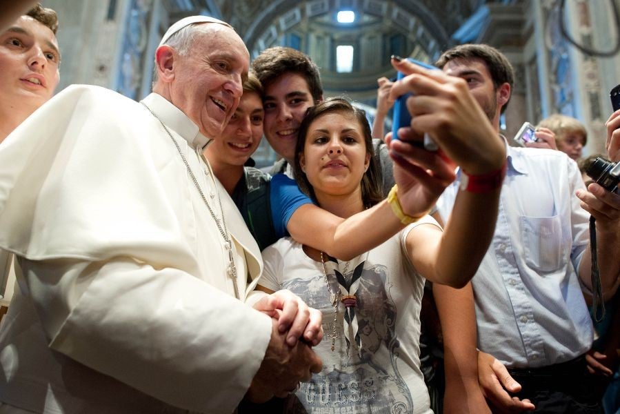 Pope Francis has his picture taken inside St. Peter's Basilica with youths from the Italian Diocese of Piacenza and Bobbio who came to Rome for a pilgrimage, at the Vatican.