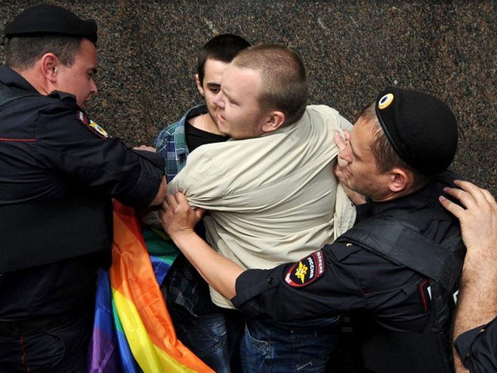 Strong-armed: Riot police hold an LGBT activist during a Moscow rally