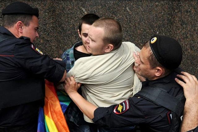 Strong-armed: Riot police hold an LGBT activist during a Moscow rally 