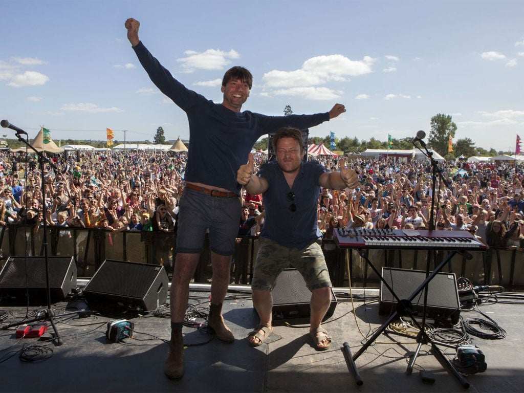 Alex James and Jamie Oliver, pictured in front of the crowd, invite traders such as Neal’sYard, to feed the middle-class masses over the two day festival