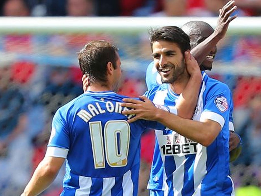 On song: Jordi Gomez celebrates after claiming the second goal for Wigan