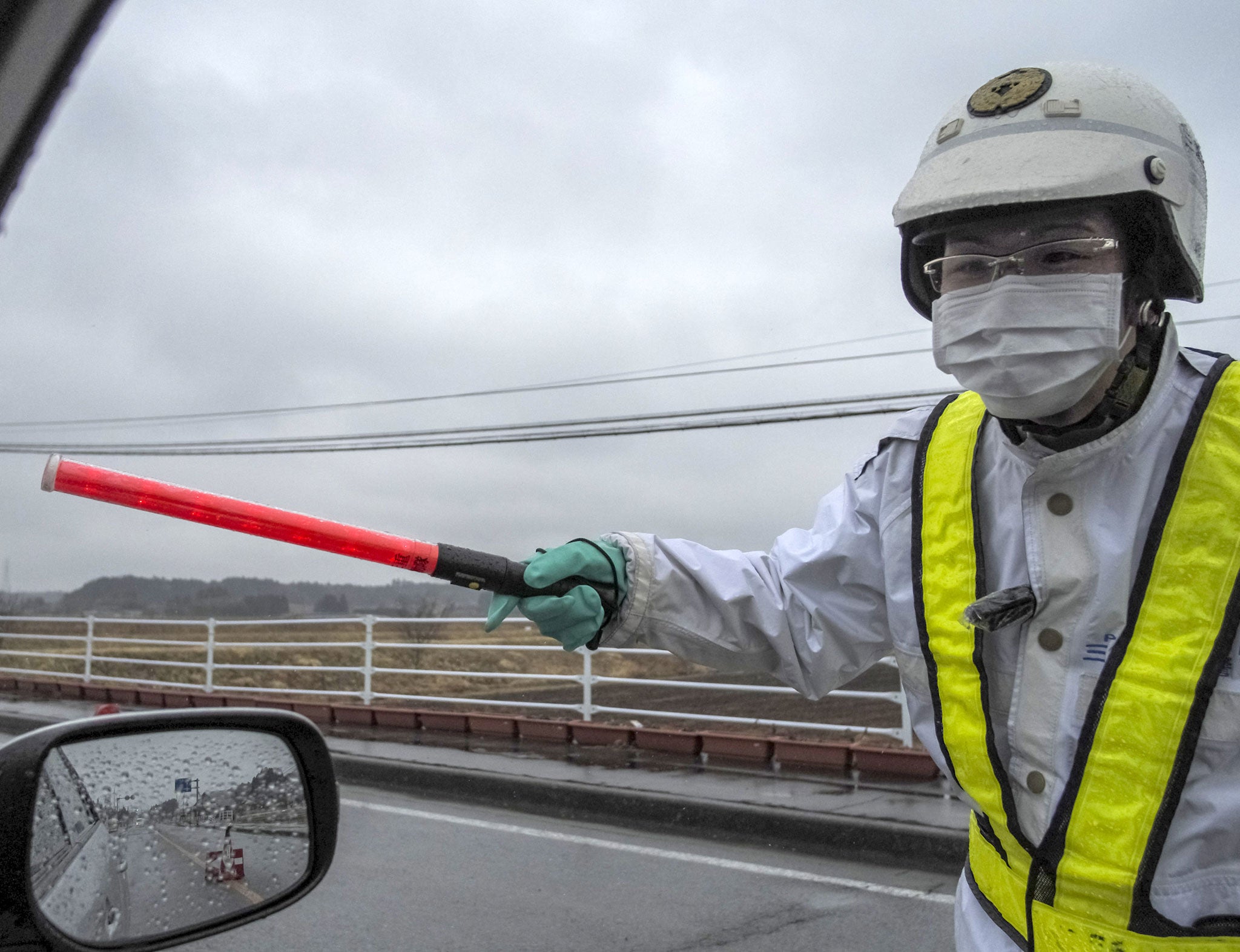 A police officer mans the perimeter around Fukushima's nuclear facility