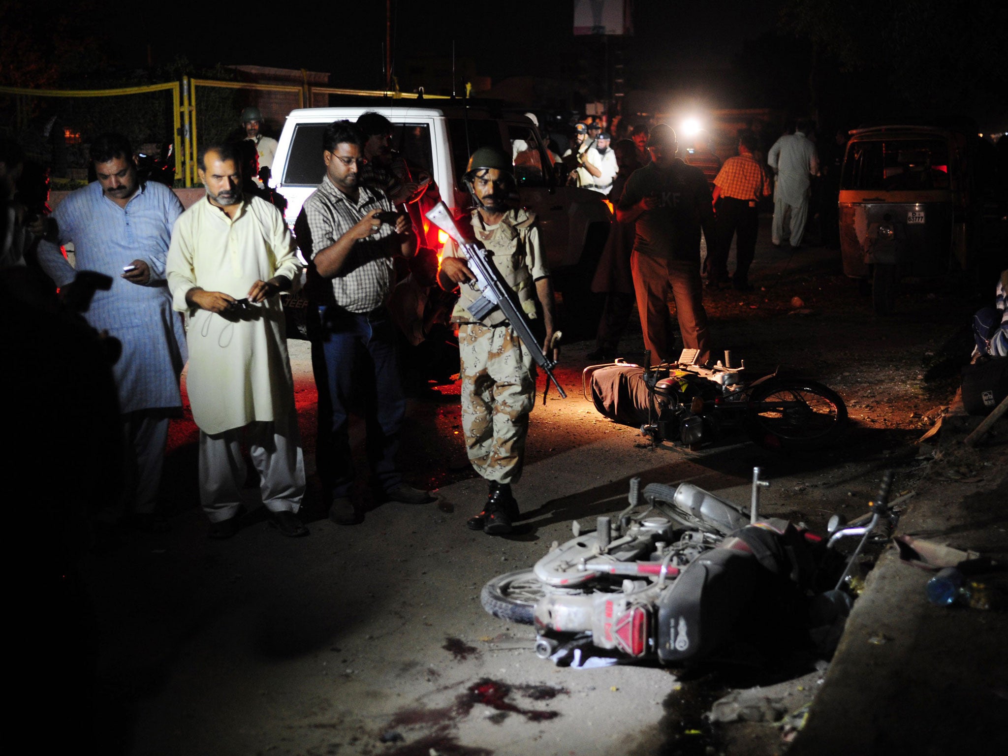 A Pakistani paramilitary soldier stands guard at the site of a bomb explosion in Karachi