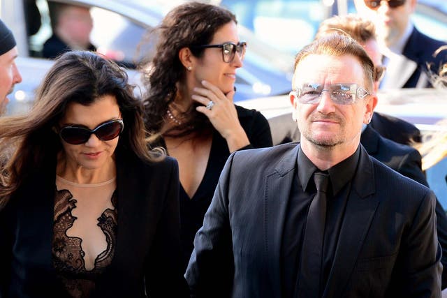 U2 singer Bono (right) arrives with his wife Ali Hewson for the funeral of Irish poet Seamus Heaney, at the Church of the Sacred Heart in Donnybrook, Dublin, Ireland