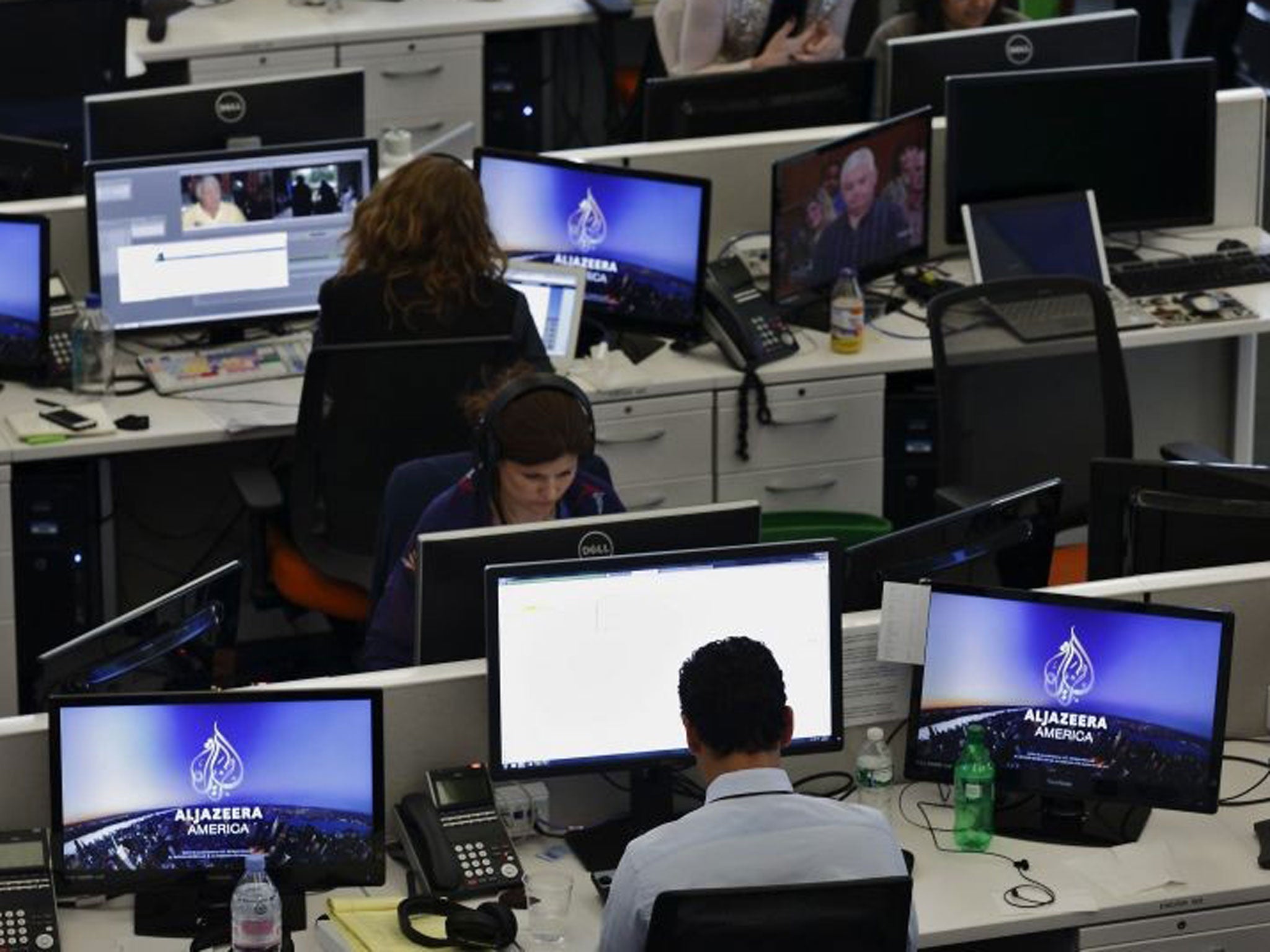 Journalists work in an Al-Jazeera news room as an Egyptian court orders Al-Jazeera Egypt to stop broadcasting. 
