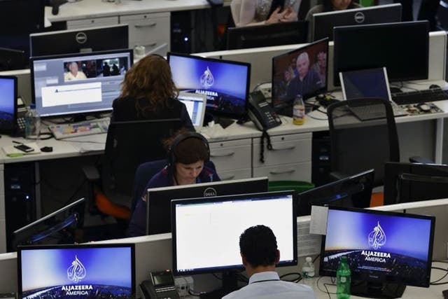 Journalists work in an Al-Jazeera news room as an Egyptian court orders Al-Jazeera Egypt to stop broadcasting.