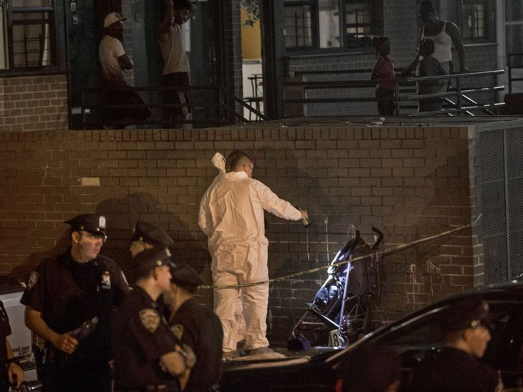 Police investigate the scene where a one-year-old was fatally shot early in the Brownsville neighborhood of the Brooklyn borough of New York, 1 September 2013