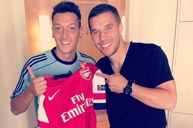 Mesut Ozil poses with new Arsenal team-mate Lukas Podolski while on duty with the Germany. Podolski, currently out with a hamstring injury, was being examined by the national team doctor  