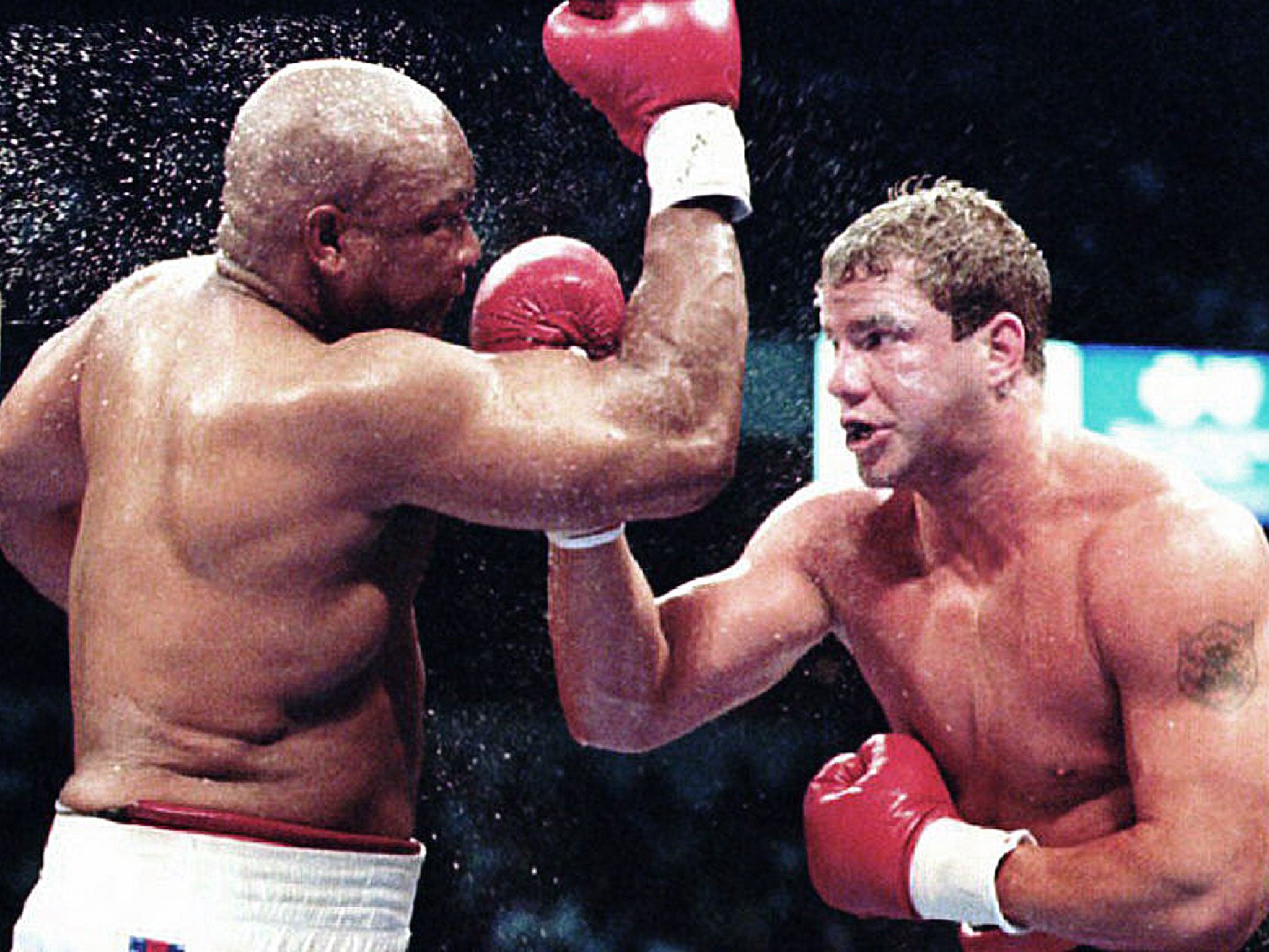 Morrison lands an uppercut on George Foreman on the way to winning the WBO world championship in Las Vegas in 1993