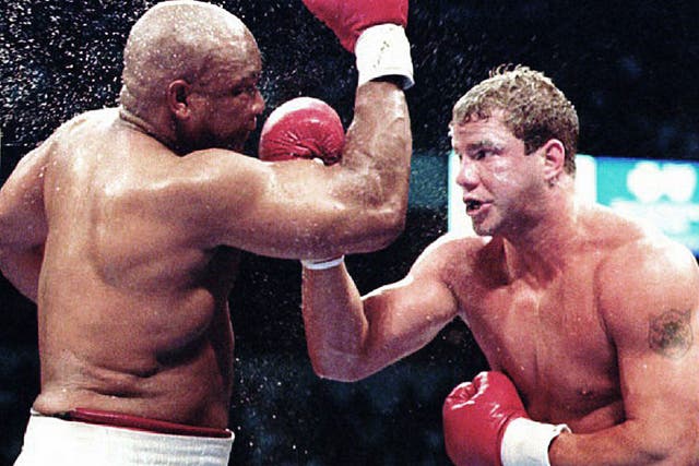Morrison lands an uppercut on George Foreman on the way to winning the WBO world championship in Las Vegas in 1993