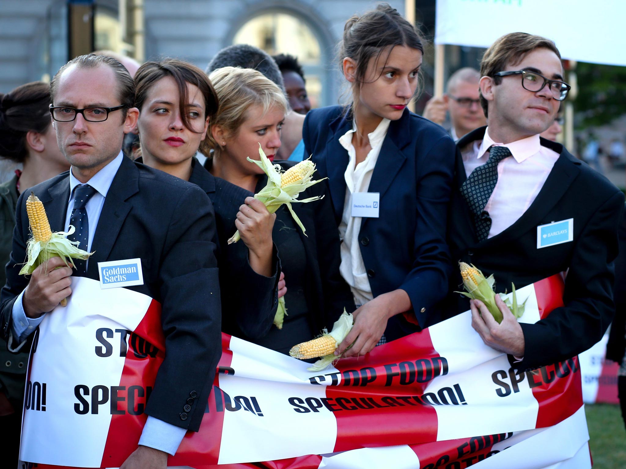 4 September 2013: Environmental activists of 'Friends of the Earth Europe' dressed as bankers hold corn cobs as they demonstrate near the European parliament in Brussels, Belgium