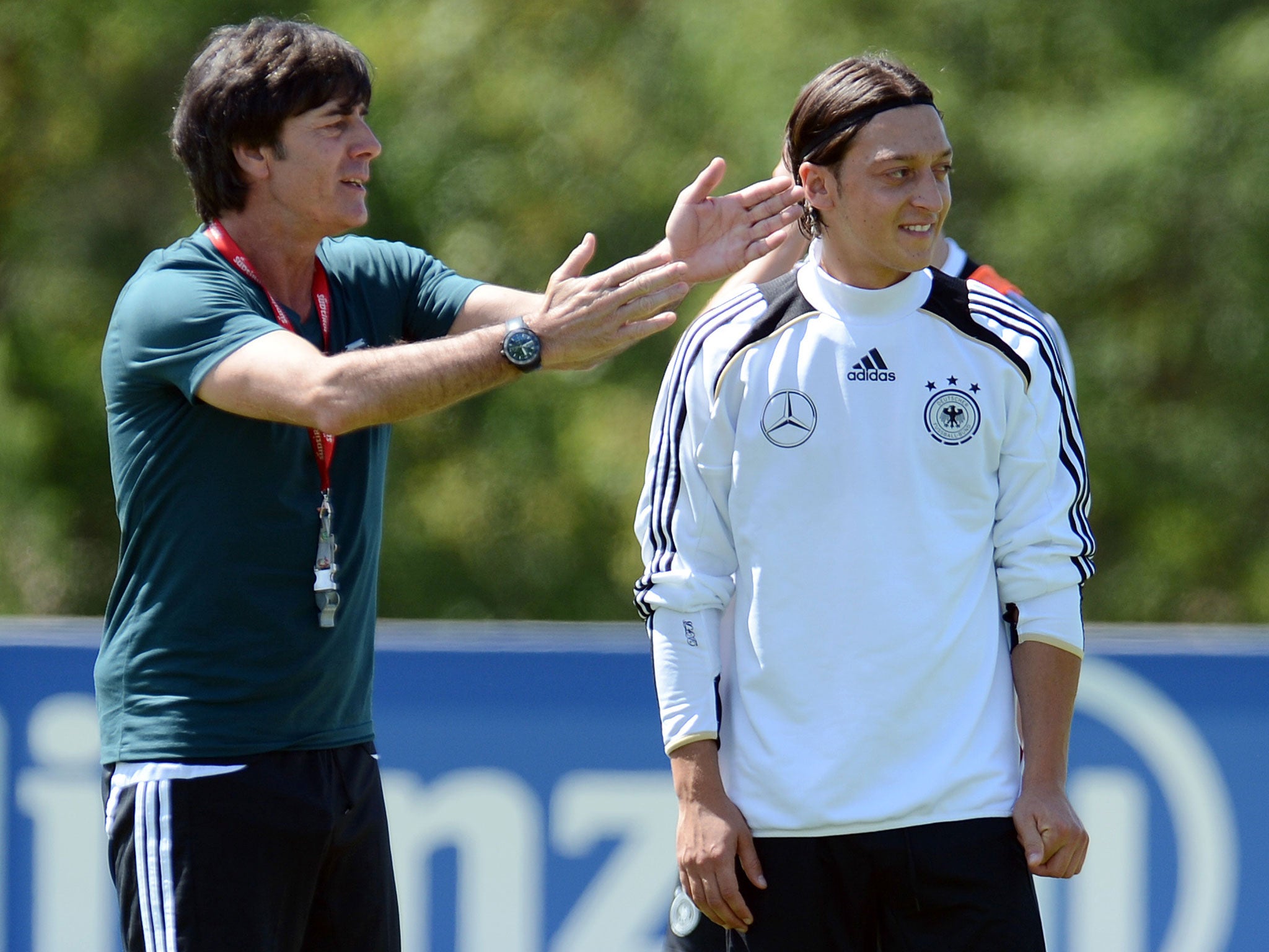 Germany boss Joachim Low alongside player Mesut Ozil