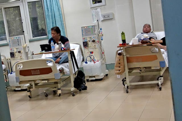 Two Chinese man receive treatment at a diabetes hospital in Beijing 