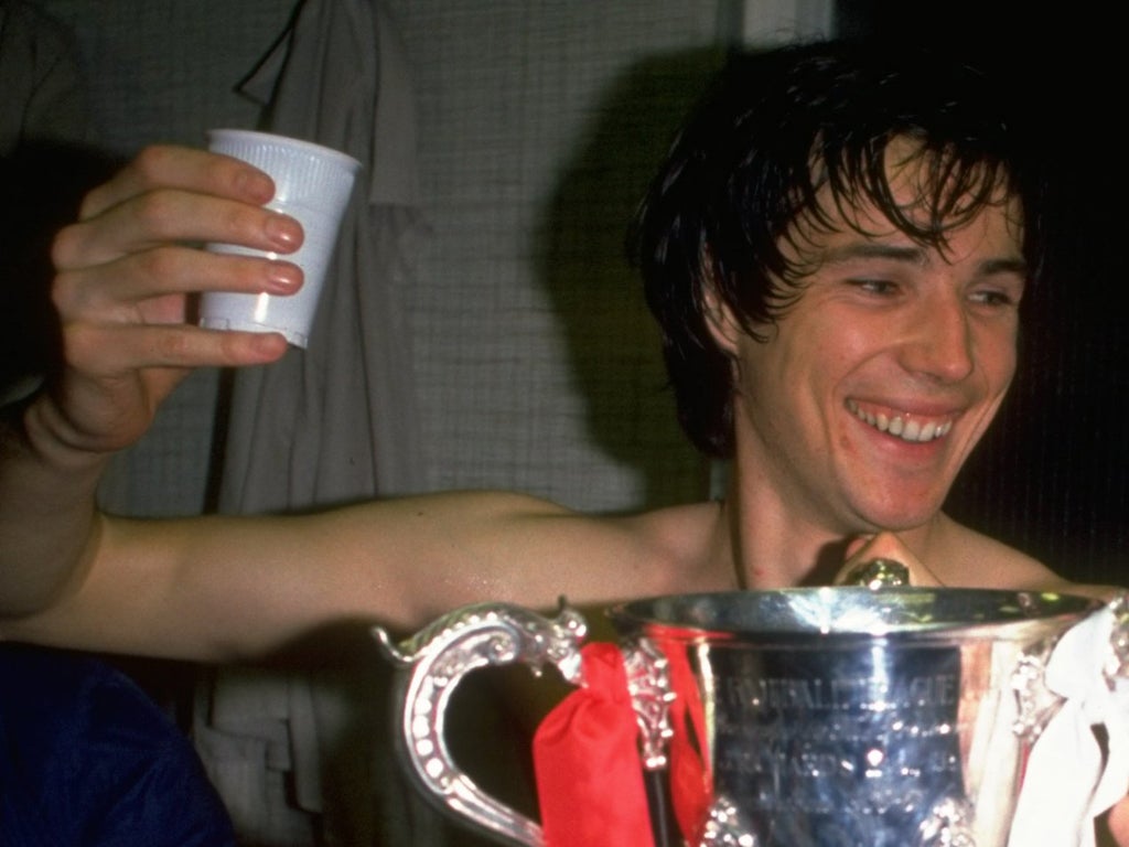 Alan Hansen of Liverpool holds the trophy to celebrate victory in the League Cup Final against West Ham at Wembley Stadium in London, 1981.