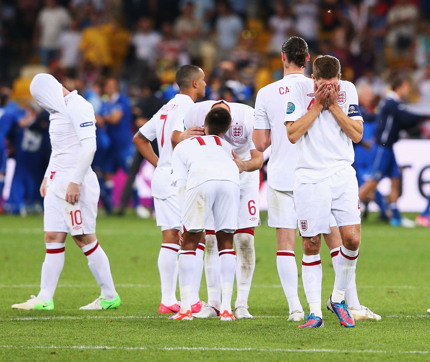 English players react to their Euro 2012 penalty shootout defeat against Italy