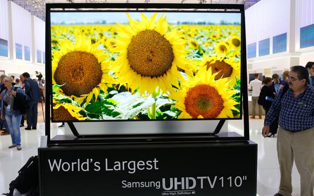 A man looks at the world's largest Samsung UHDTV 110 inch screen at the booth of Samsung during a media preview day at the IFA consumer electronics fair in Berlin, September 5, 2013.