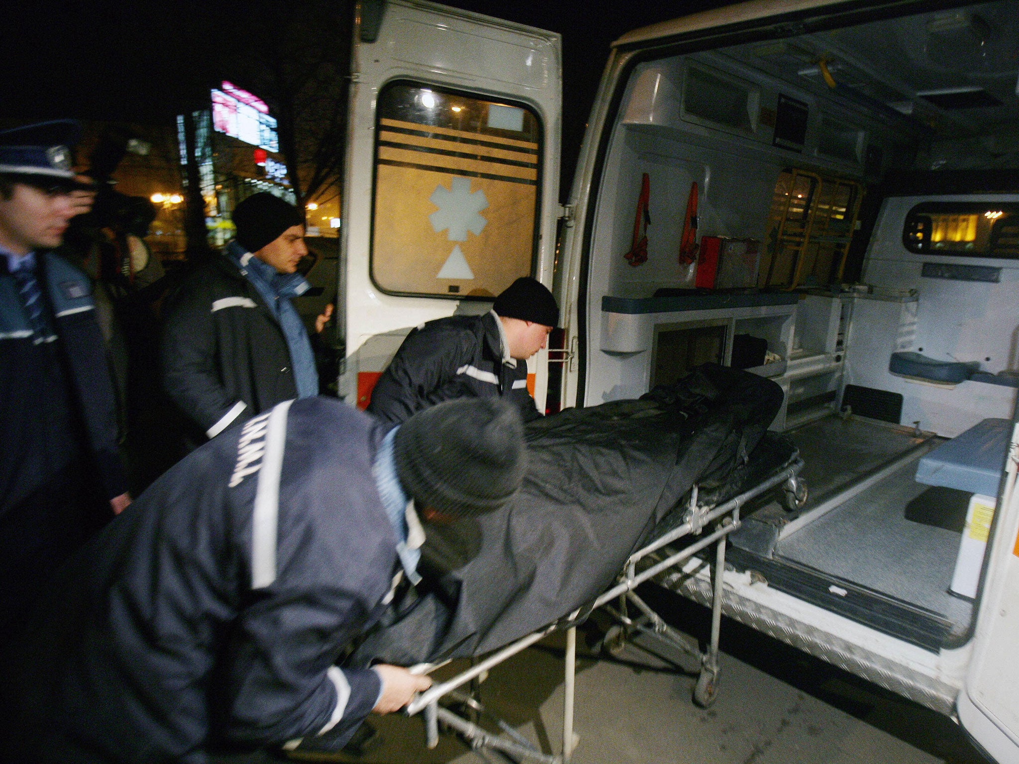 A man killed by a dog is loaded into an ambulance (AFP/Getty)