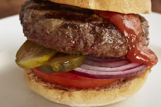 Hamburger with club sauce, red onions, pickled gherkins and beef tomatoes