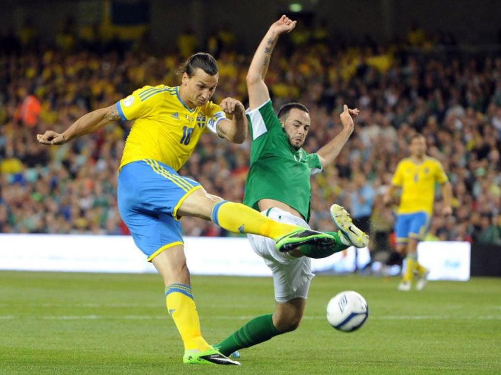 Marc Wilson (right) tries to stop Sweden’s Zlatan Ibrahimovic