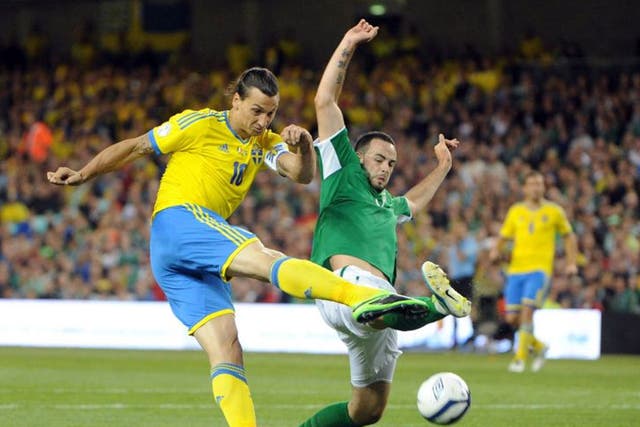 Marc Wilson (right) tries to stop Sweden’s Zlatan Ibrahimovic