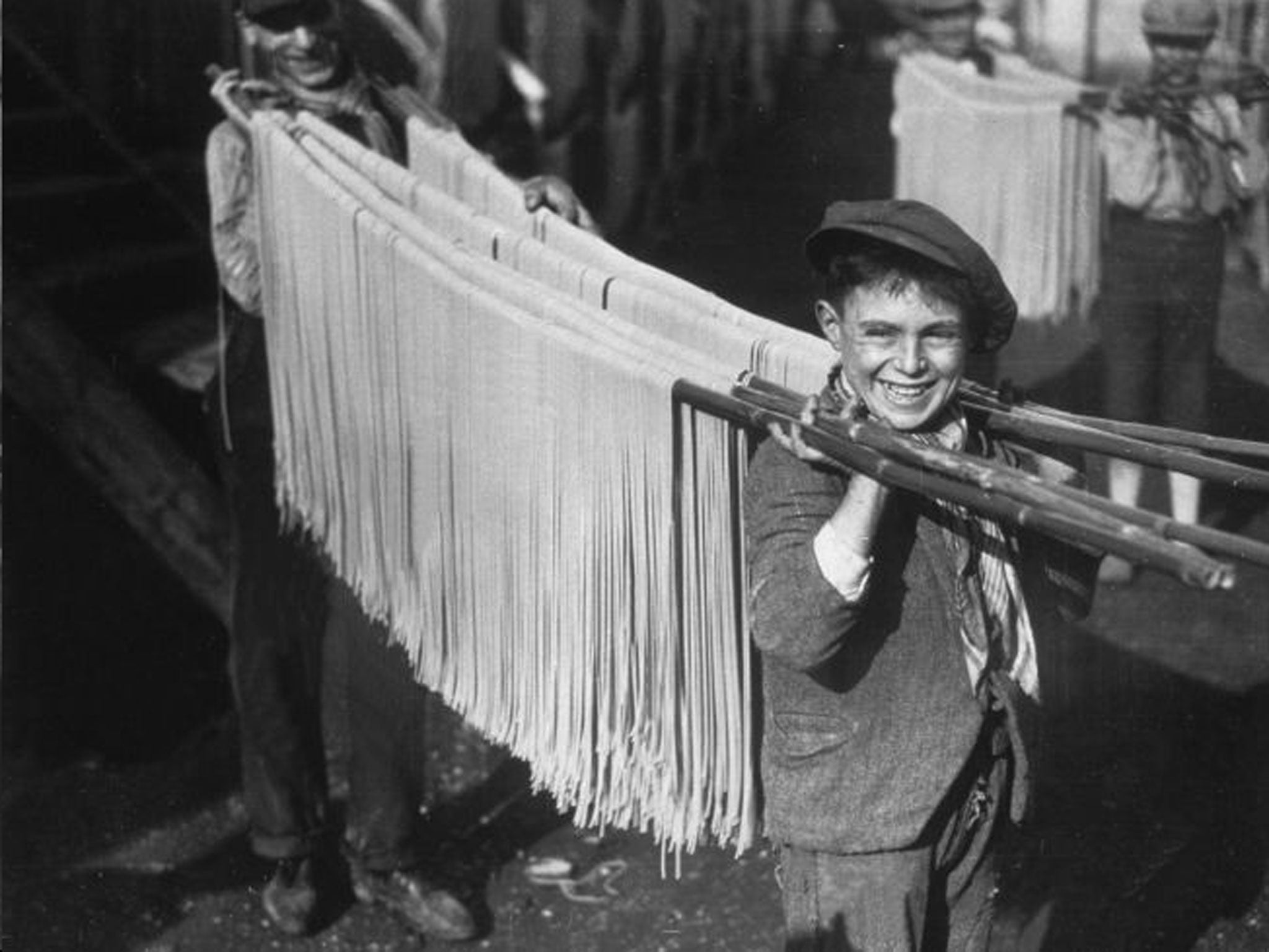 Buona! Boys carry spaghetti in 1929 Naples. Inset, Gennaro Contaldo