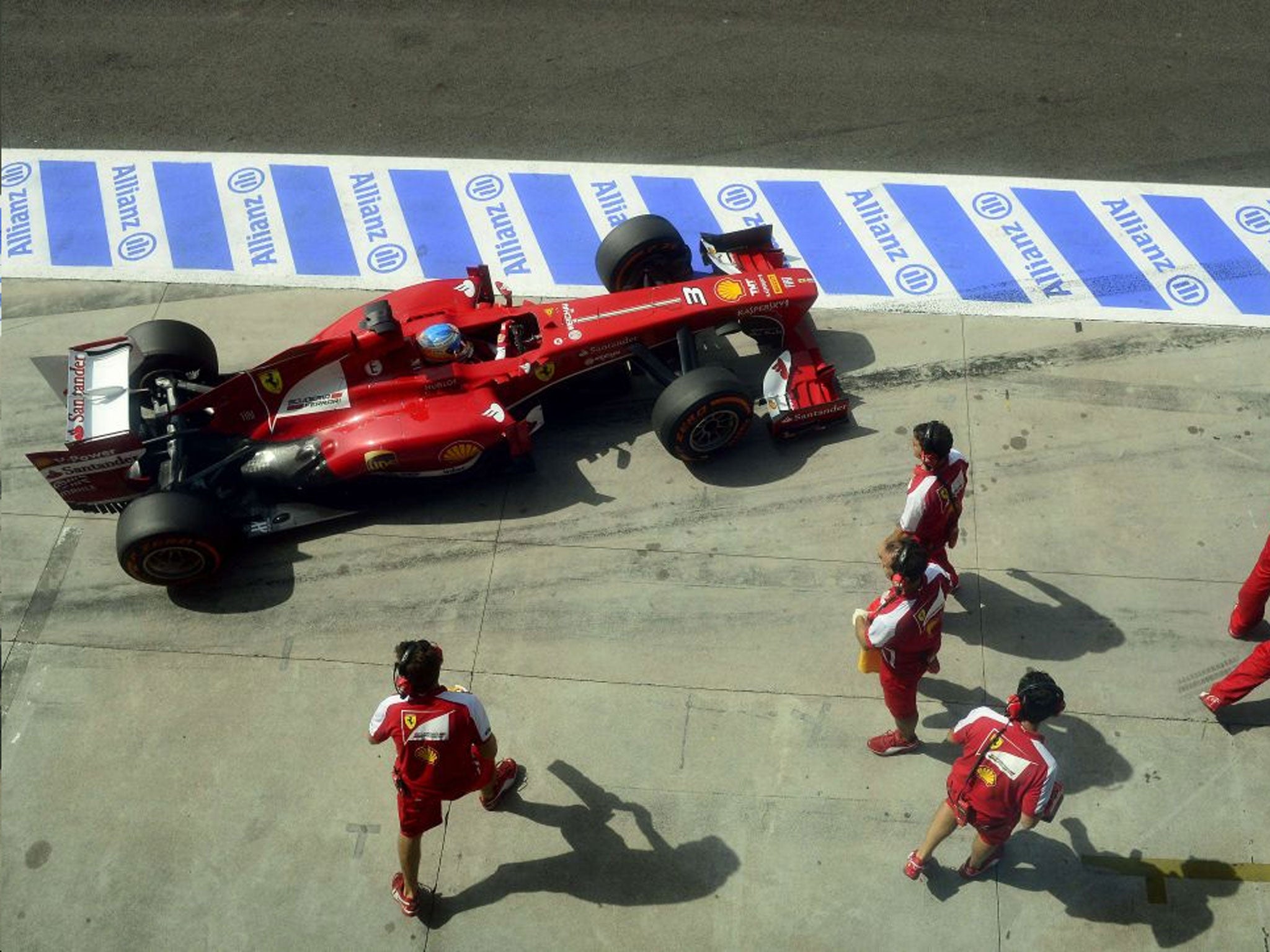 Stand-off: Fernando Alonso drives into the pits during his ill-fated qualifying session yesterday
