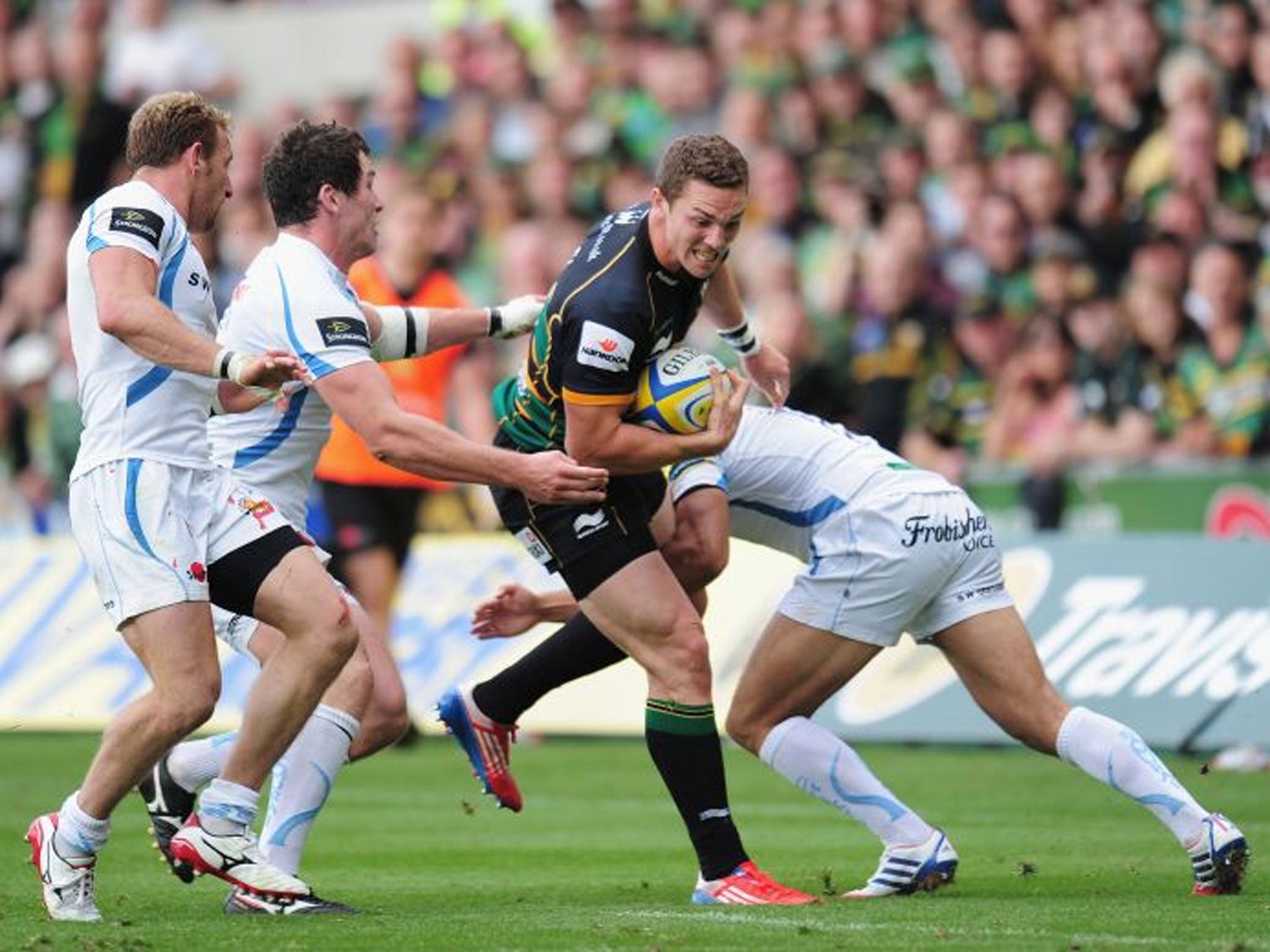 One direction: Northampton Saints winger George North barges his way through the Exeter defence