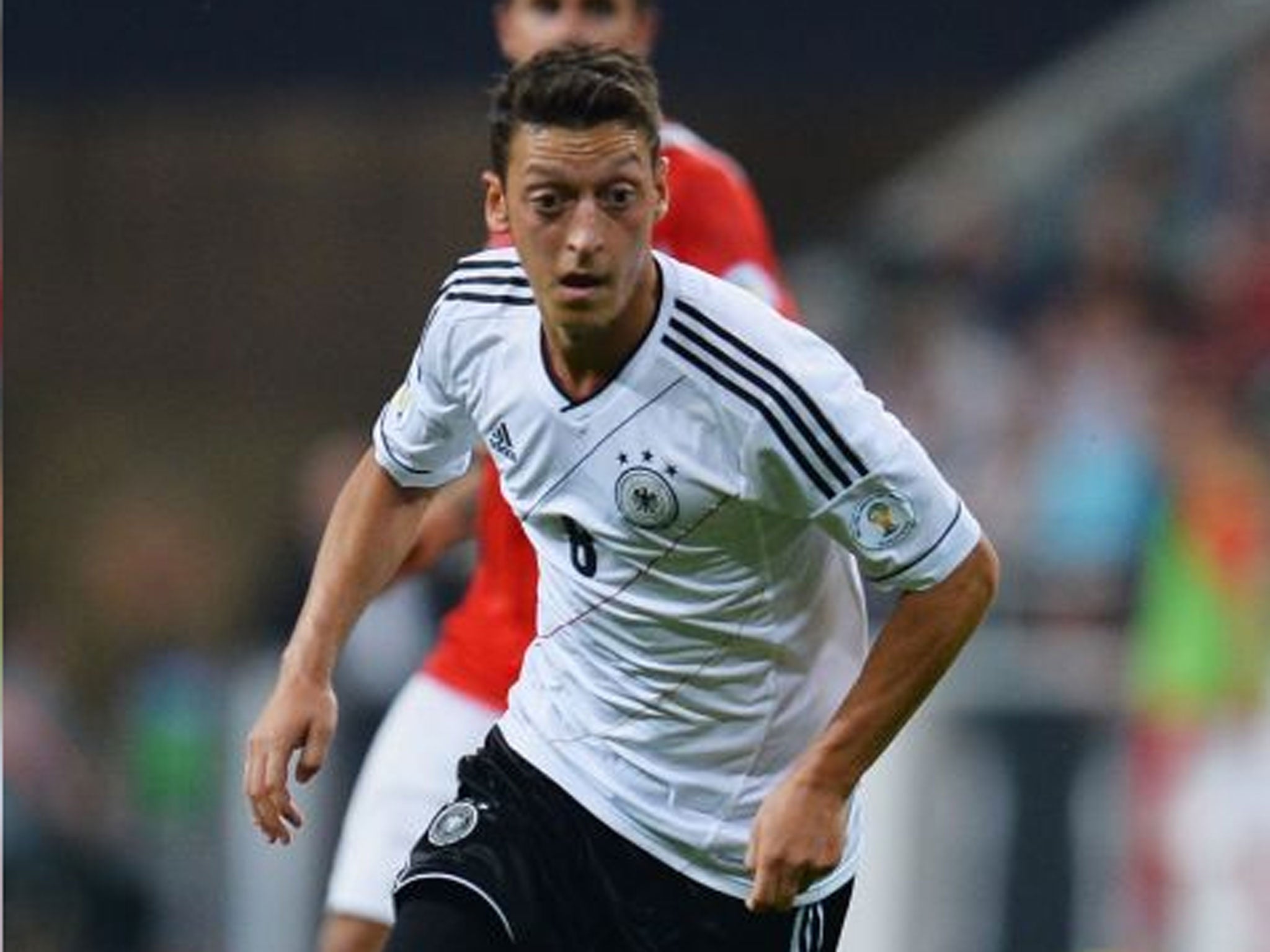 Teutonic night: Mesut Ozil takes centre stage to inspire Germany to a 3-0 victory against Austria in Munich on Friday