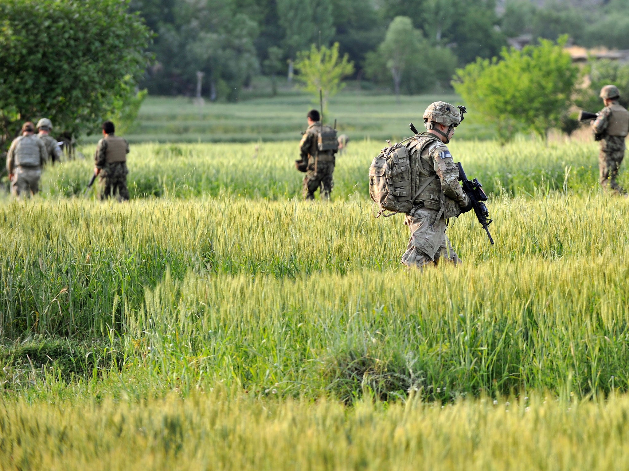 US army soldiers along with the soldiers of Afghan National Army (ANA) march through Watahpur District in Kunar province